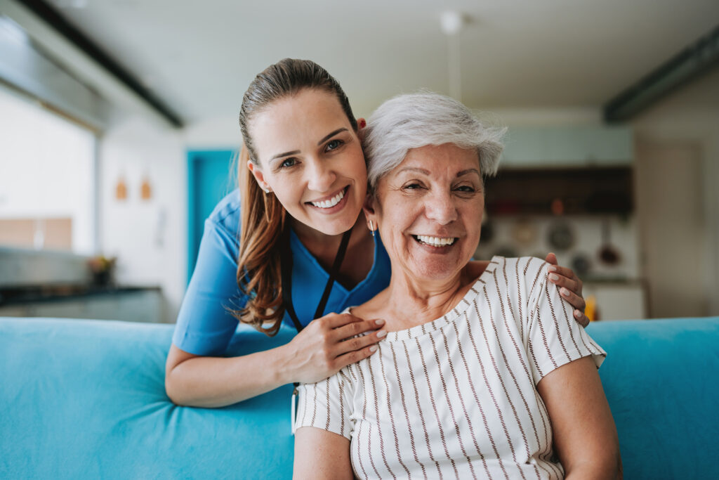 Healthcare professional hugging senior patient
