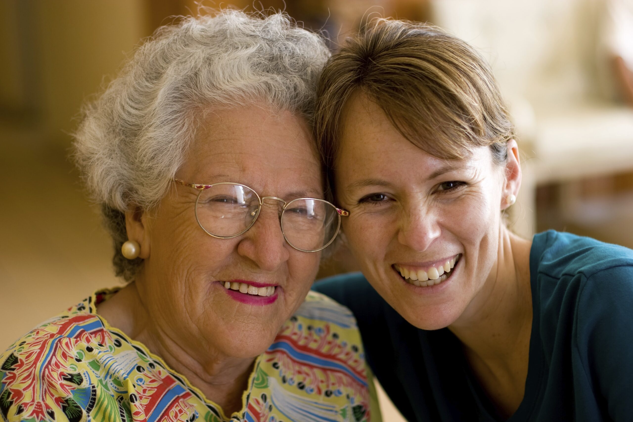 Healthcare worker hugging an elderly woman