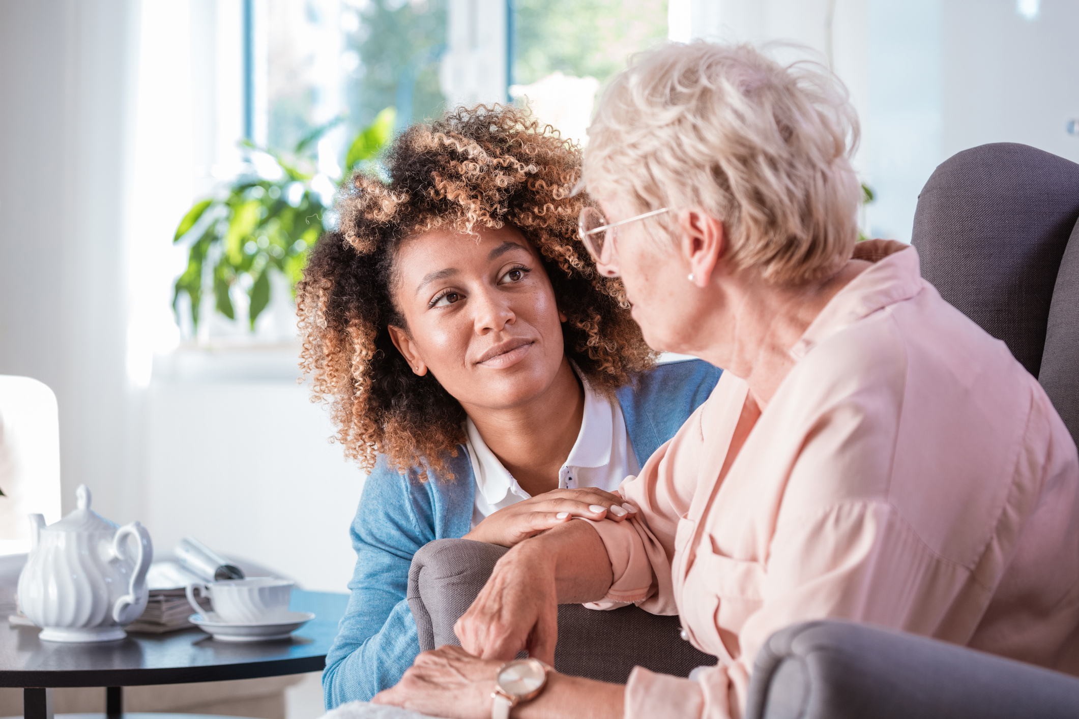 Friendly nurse taking care of an elderly lady
